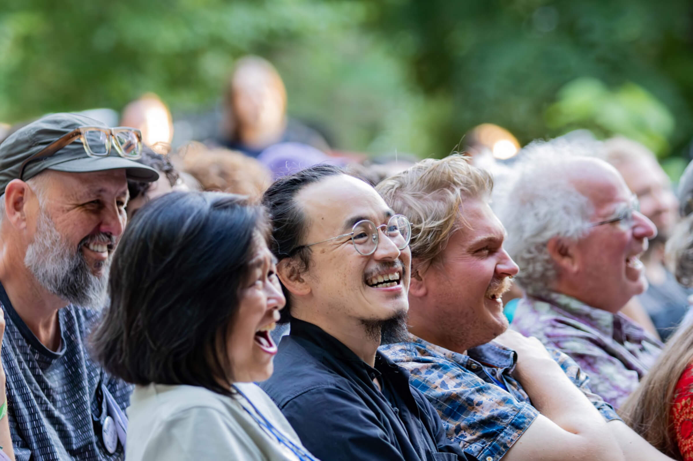 Wendy Hanamura, Tony Lai, Ian Davis and Brewster Kahle enjoy a laugh at the Opening Ceremony of DWeb Camp 2026.